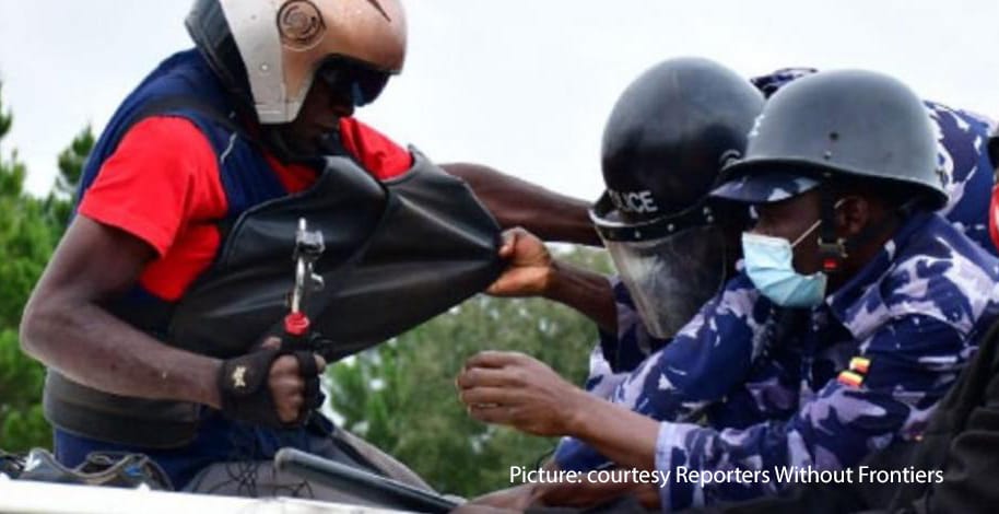 A radio reporter is challenged by police in Uganda during demonstrations in December in the Presidential election campaign.